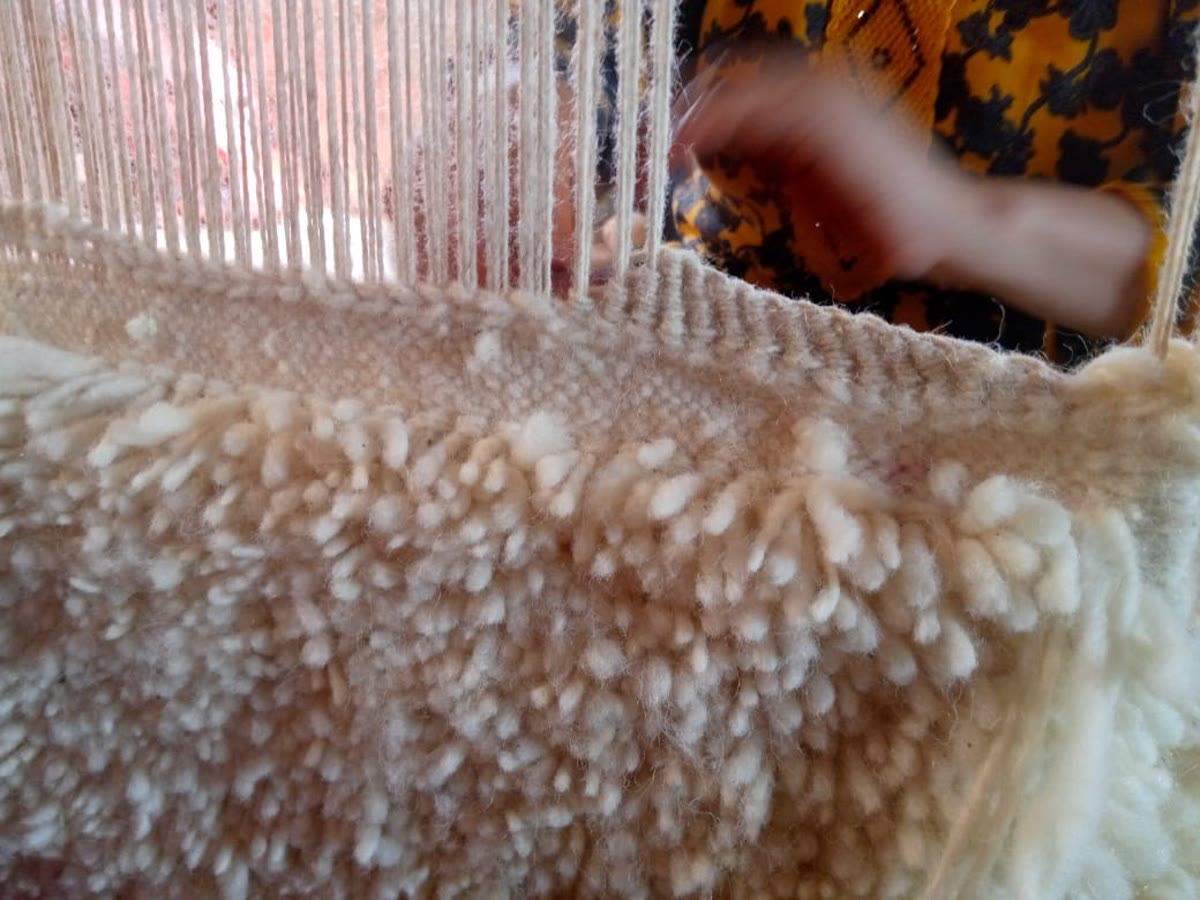 Close-up detail of Nestaground handmade rug texture and natural wool pile