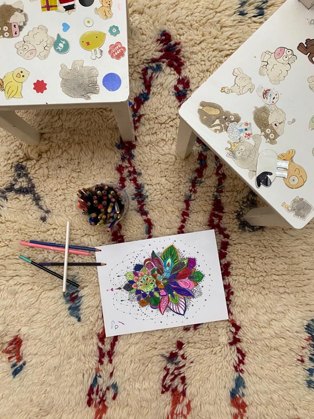 Child drawing and creating on a Nestaground organic wool rug